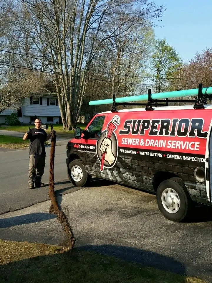 Superior Sewer & Drain Service van in Groton, CT, with plumber and drain cleaning equipment.