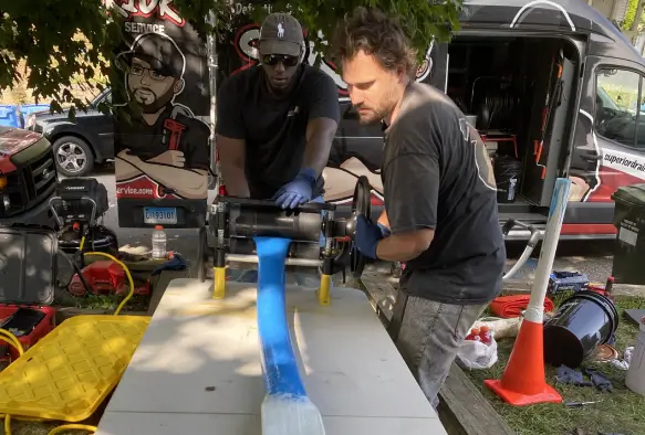Superior Sewer & Drain Service technicians performing trenchless pipe lining repair in Connecticut or Rhode Island.