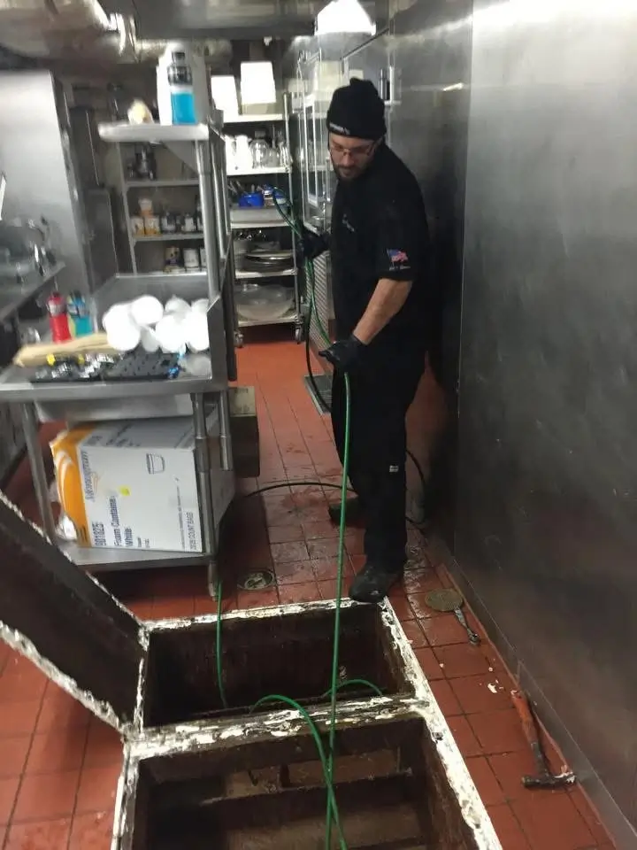 Plumber clearing a commercial drain in Westerly, Rhode Island.